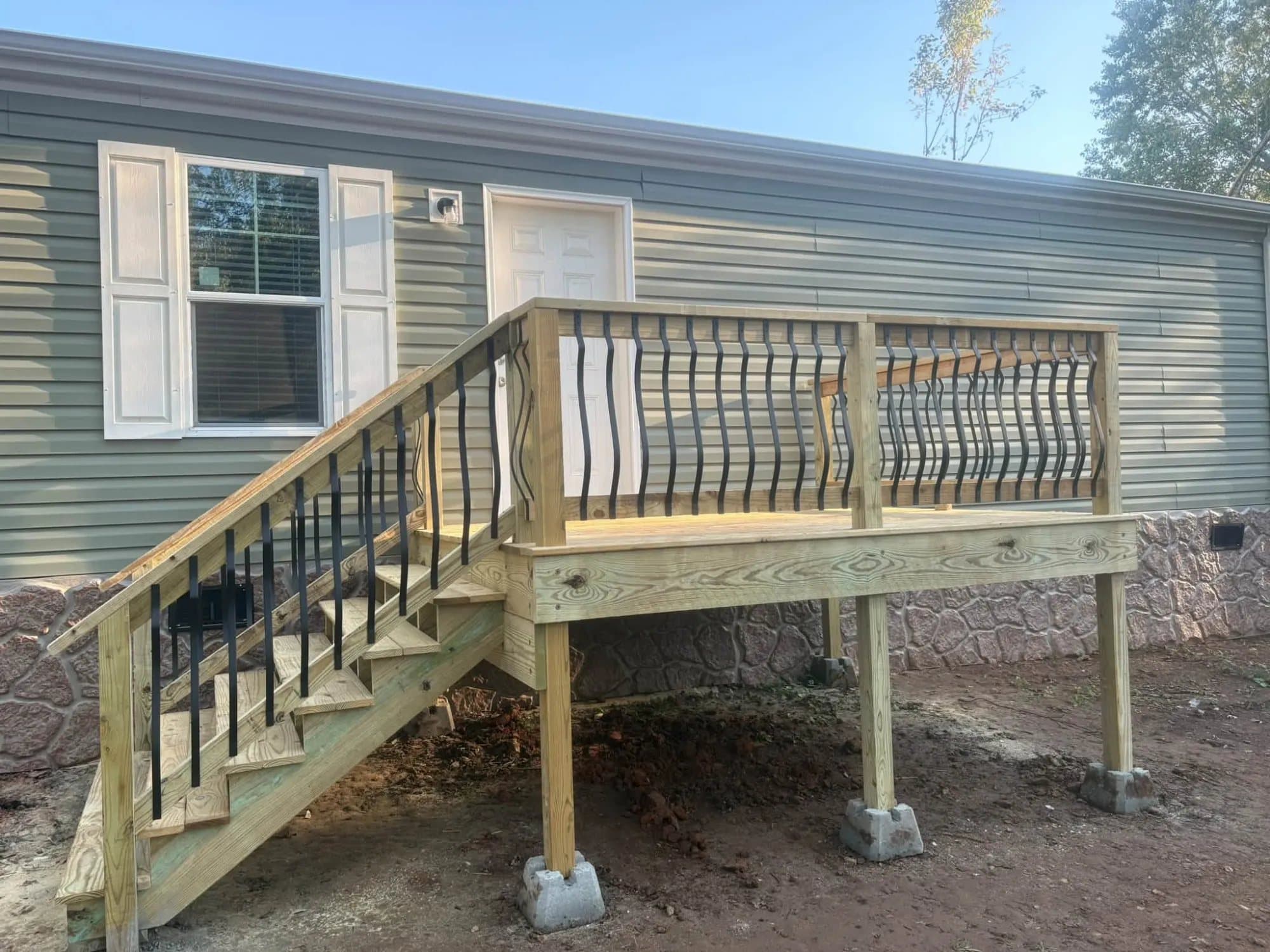 Finished wood deck with stairs and black balusters